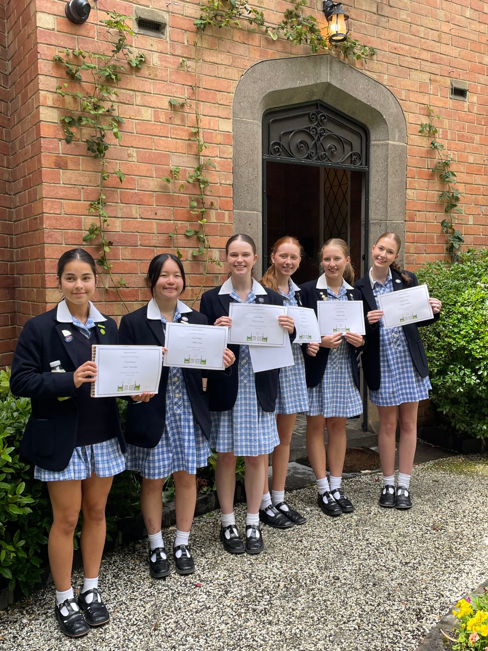 Strathcona students holding certificates at Presentation Day 2025 at Invergowrie