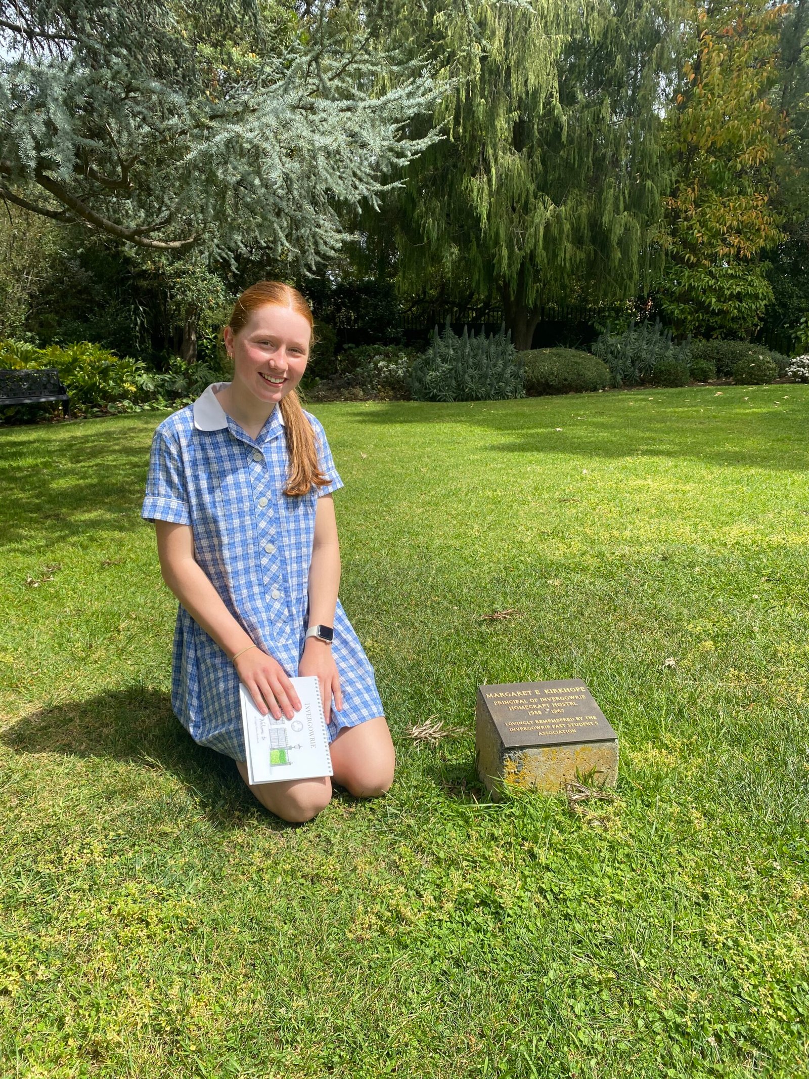 Strathcona Student next to Margaret Kirkhope memorial plaque