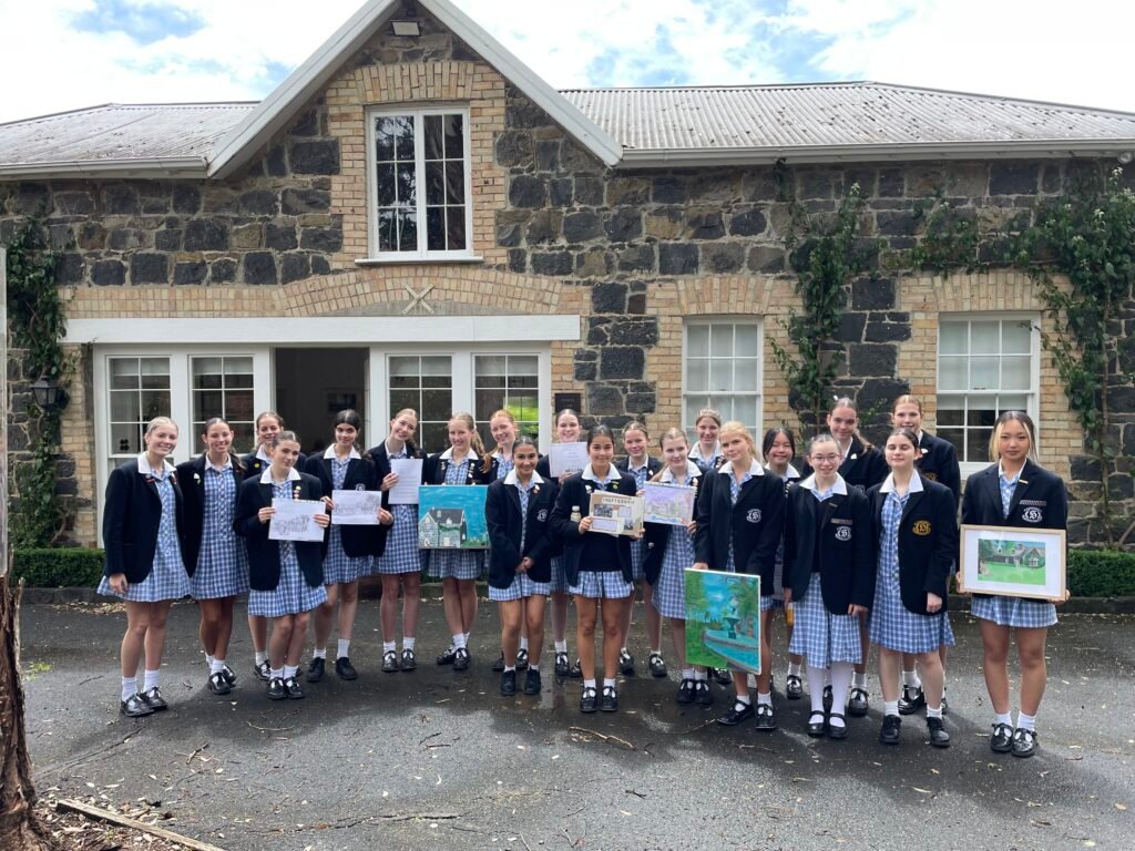Strathcona students displaying their creative projects in front of the original Stables building